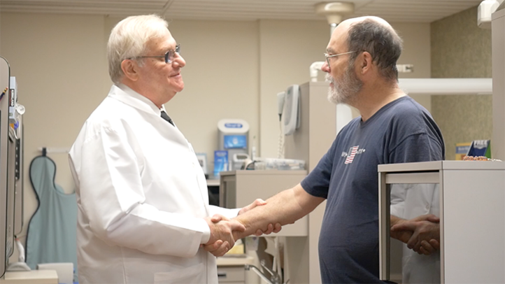 Dr. Hughes greets a dental implant patient